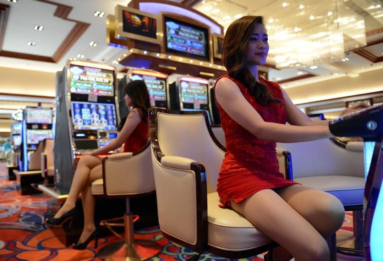 Employees of Solaire Manila Resorts and casino pose for a photo inside the casino, in Manila, on March 14, 2013