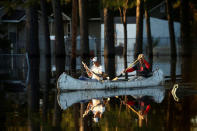 Residents paddle a canoe to their home to recover items from flood waters as a result of Hurricane Matthew in Lumberton, North Carolina, U.S. October 12, 2016. REUTERS/Carlo Allegri