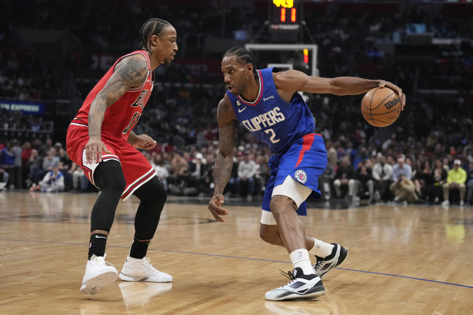 Los Angeles Clippers forward Kawhi Leonard (2) is defended by Chicago Bulls forward DeMar DeRozan during the first half of an NBA basketball game Monday, March 27, 2023, in Los Angeles. (AP Photo/Marcio Jose Sanchez)