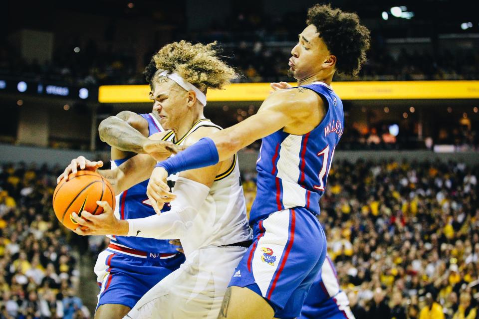 Missouri forward Noah Carter (left) get harassed by a Kansas defender during the Tigers' Border War game against Kansas on Dec. 10, 2022, at Mizzou Arena in Columbia, Mo.