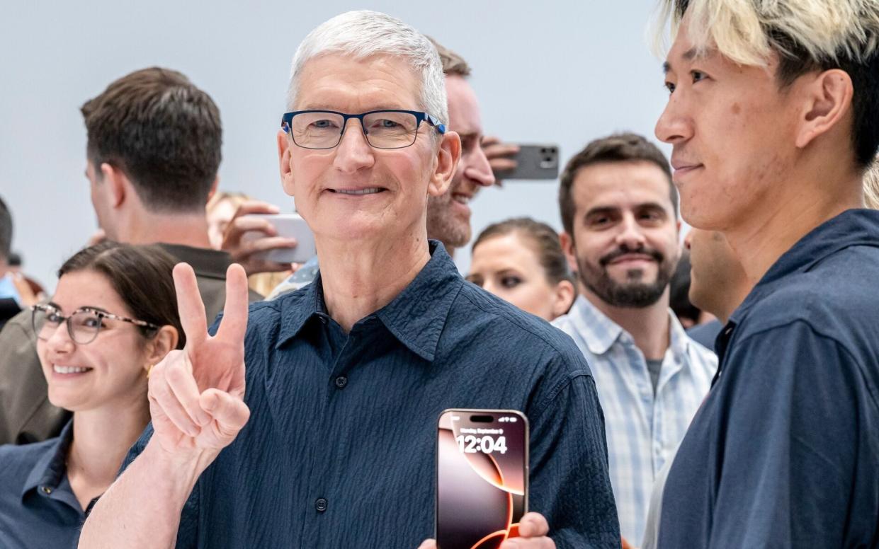 Apple chief executive Tim Cook with the new iPhone 16