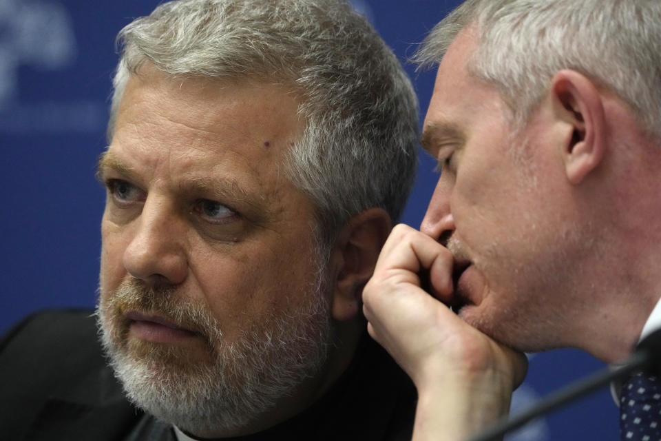 Pope's spoke person Matteo Bruni, right, talks with father Giacomo Costa during a presentation of the new guidelines for the Synod of Bishops at the Vatican, Tuesday, June 20, 2023. (AP Photo/Domenico Stinellis)