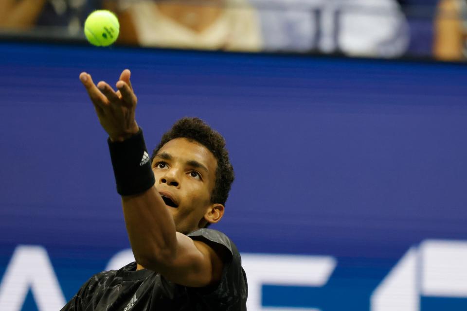 Felix Auger-Alliassime serves during his U.S. Open quarterfinal match against Carlos Alcaraz.