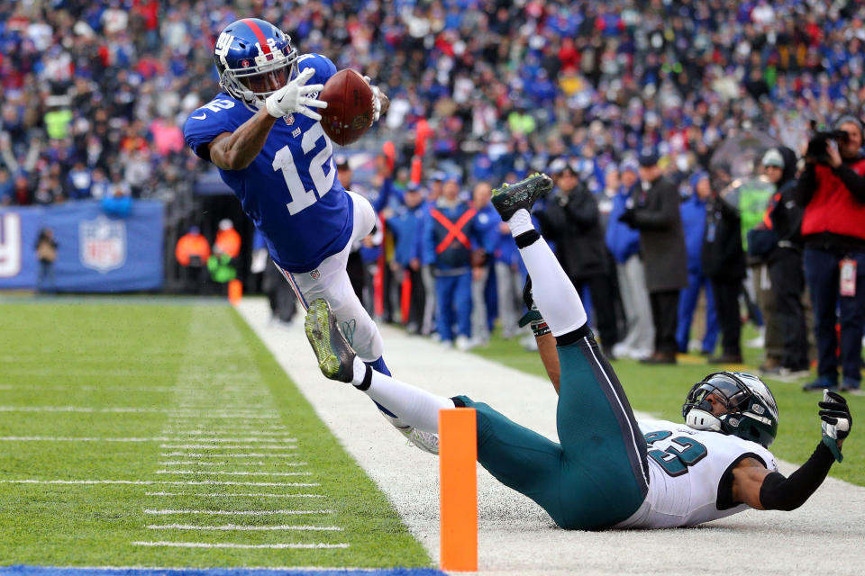 <p>New York Giants wide receiver Tavarres King (12) runs for a touchdown against Philadelphia Eagles safety Rodney McLeod (23) during the third quarter at MetLife Stadium. Mandatory Credit: Brad Penner-USA TODAY Sports </p>