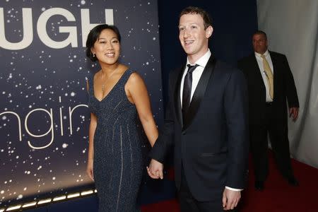 Mark Zuckerberg (R), founder and CEO of Facebook, and wife Priscilla Chan arrive on the red carpet during the 2nd annual Breakthrough Prize Award in Mountain View, California November 9, 2014. REUTERS/Stephen Lam