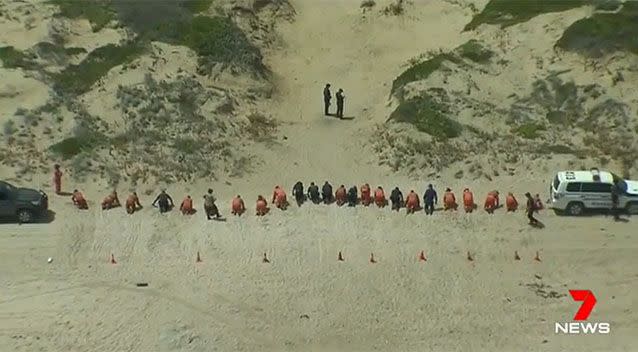 Detectives and SES workers scoured the sand for evidence in February. Photo: 7 News