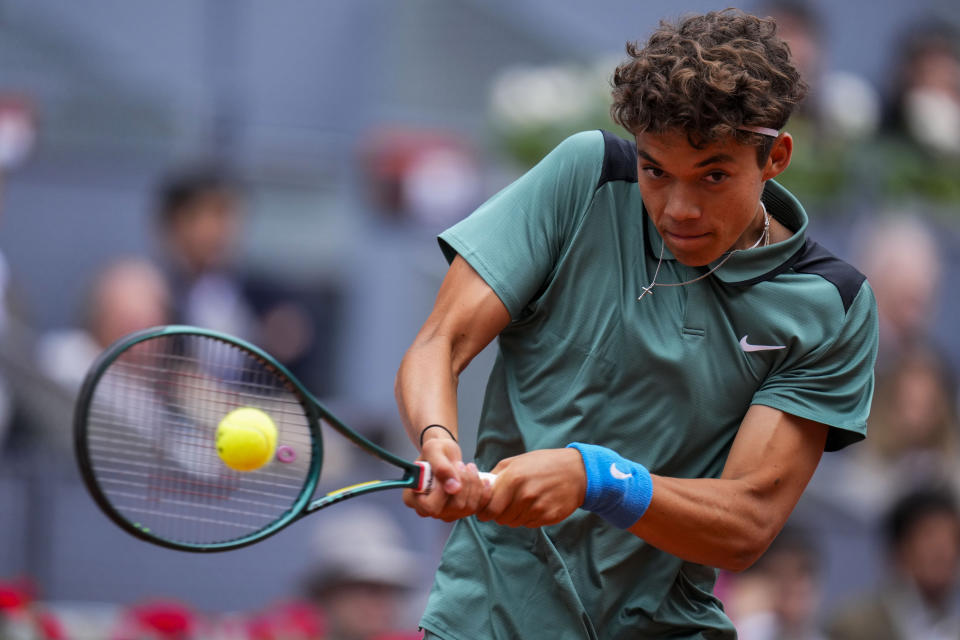 Darwin Blanch of United States returns the ball to Rafael Nadal of Spain during the Mutua Madrid Open tennis tournament in Madrid, Thursday, April 25, 2024. (AP Photo/Manu Fernandez)