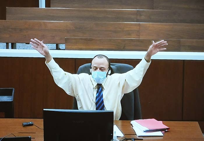 Darrell Brooks is seen watching video of proceedings from a separate room after the judge removed him from the courtroom.