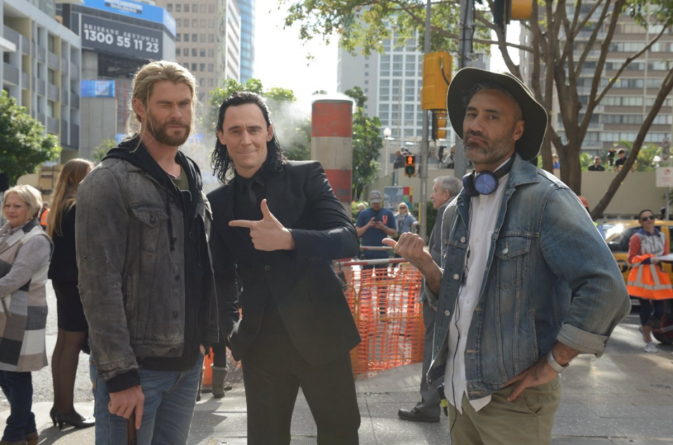 Chris Hemsworth, Tom Hiddleston, and Taika Waititi on the set of 'Thor 3' - Credit: Twitter/Daley_Pearson