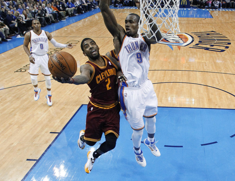 Cleveland Cavaliers guard Kyrie Irving (2) shoots in front of Oklahoma City Thunder forward Serge Ibaka (9) during the fourth quarter of an NBA basketball game in Oklahoma City, Wednesday, Feb. 26, 2014. Cleveland won 114-104. (AP Photo/Sue Ogrocki)