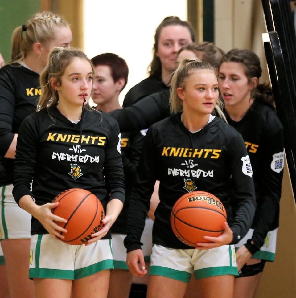 Northeastern freshman Ady Kircher (left) and sophomore Ava Mikesell (right) prepare to take the court for a game against Muncie Central Nov. 8, 2022.