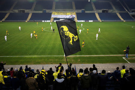 Betar Nordia Jerusalem supporters wave a flag during a match against Hakoah Maccabi Amidar Ramat Gan Football Club at Teddy Stadium in Jerusalem, January 29, 2018. REUTERS/Ronen Zvulun