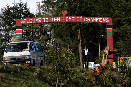 A woman walks past a sign on a public road welcoming people to the town of Iten, western Kenya, April 12, 2016. REUTERS/Siegfried Modola