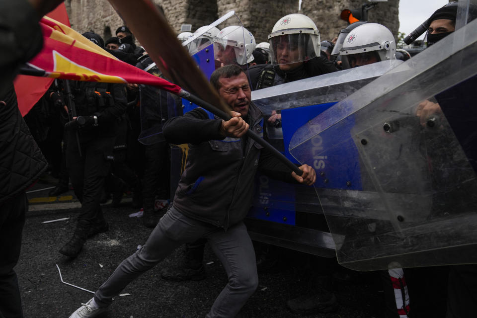 Union members clash with Turkish anti riot police officers as they march during Labor Day celebrations in Istanbul, Turkey, Wednesday, May 1, 2024. (AP Photo/Khalil Hamra)