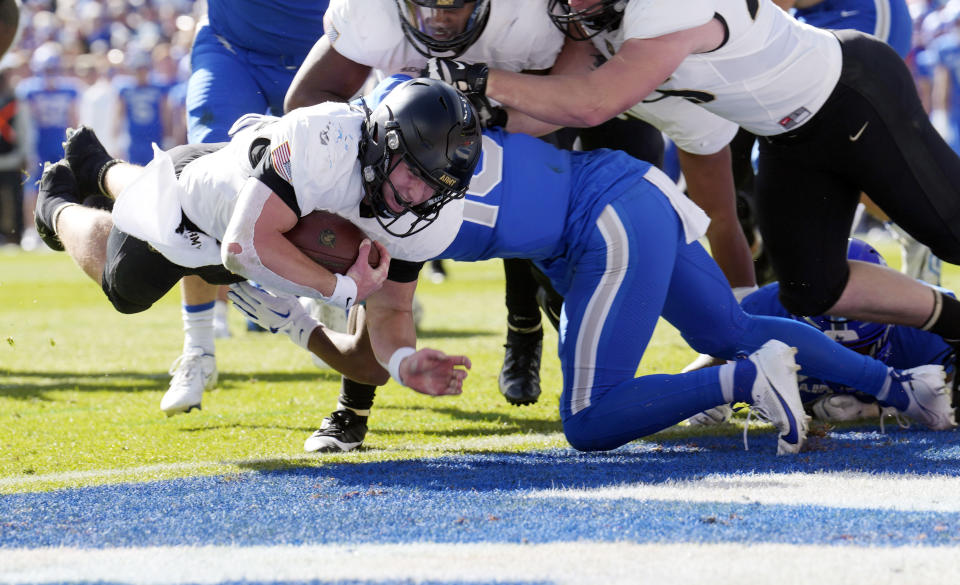 Army quarterback Bryson Daily, left, dives into the end zone for a touchdown past Air Force safety Jayden Goodwin in the first half of an NCAA college football game Saturday, Nov. 4, 2023, in Denver. (AP Photo/David Zalubowski)