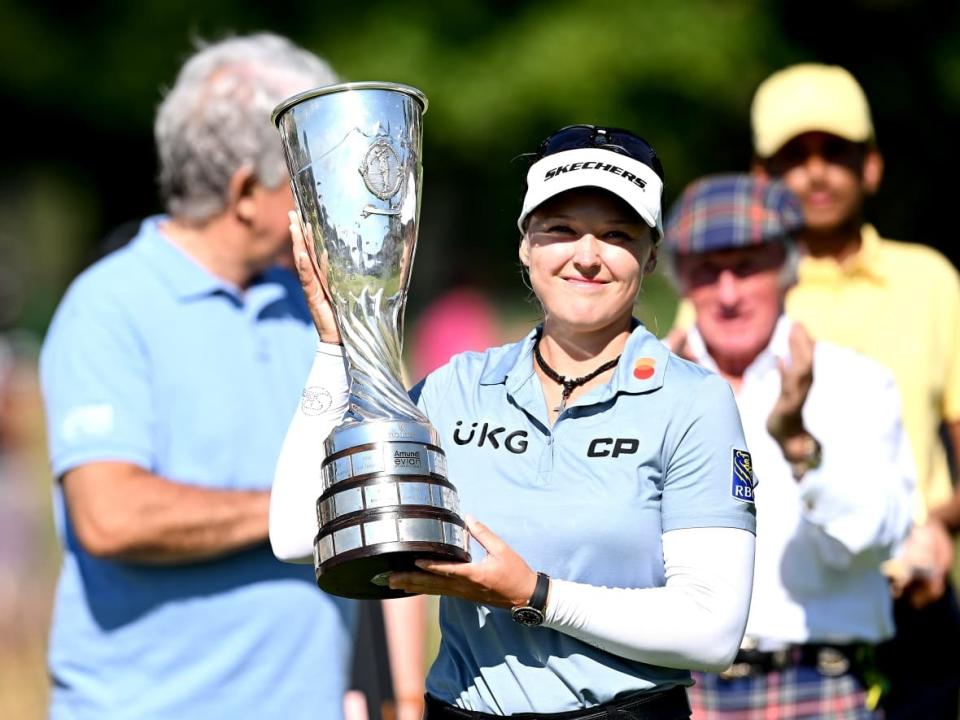 Brooke Henderson of Canada lifts the trophy after winning the The Amundi Evian Championship on Sunday at the Evian Resort Golf Club in Evian-les-Bains, France. (Stuart Franklin/Getty Images - image credit)