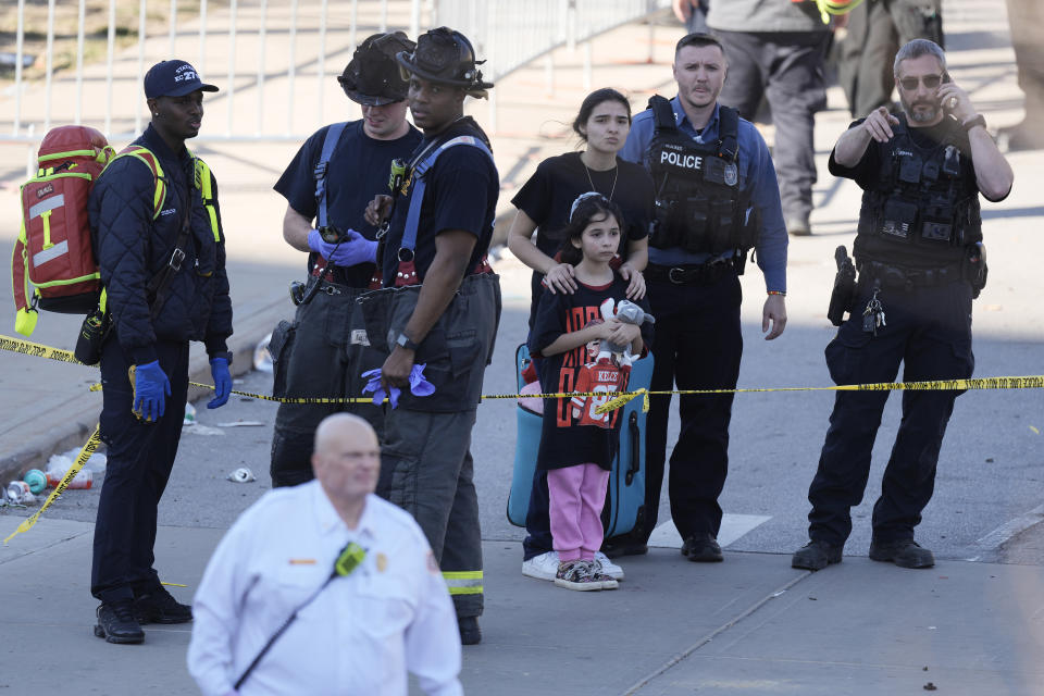 Emergency worker direct people leaving a victory rally celebrating the Kansas City Chiefs Super Bowl 58 win after a shooting following the event Wednesday, Feb. 14, 2024, at Union Station in Kansas City. Mo. (AP Photo/Charlie Riedel)