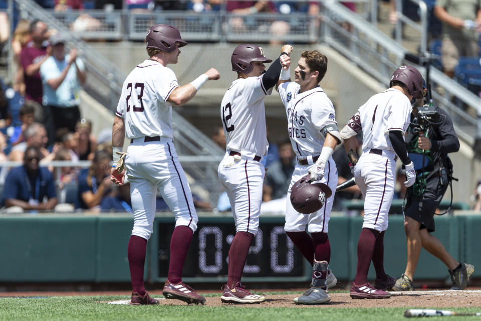 Texas A&M Jordan Thompson, third from left, celebrates his three-run home run with teammates Brett Minnich (23) and Troy Claunch (12) in the second inning against Oklahoma in the during an NCAA College World Series baseball game Friday, June 17, 2022, in Omaha, Neb. (AP Photo/John Peterson)