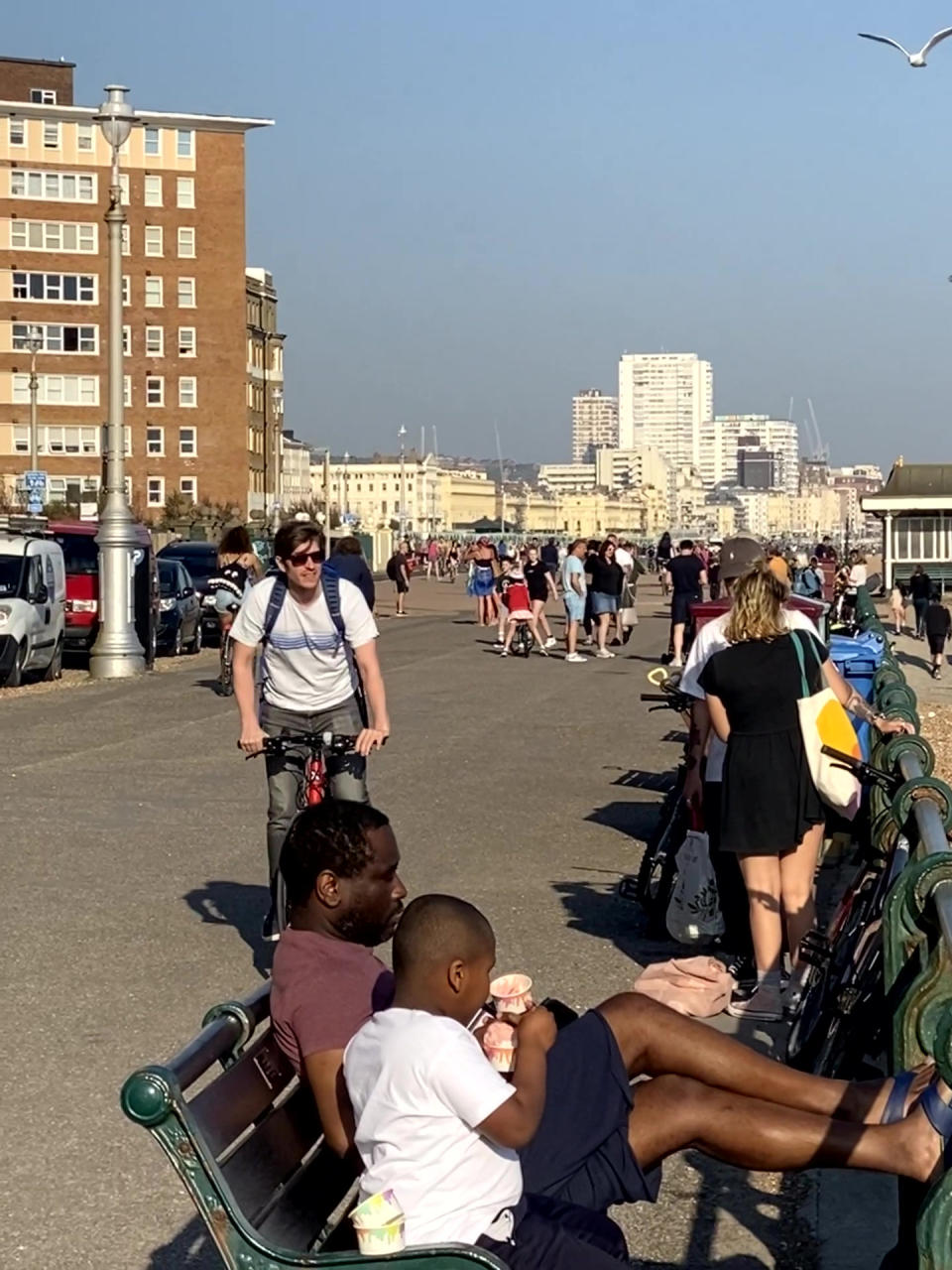 This photo shows a totally packed seafront as lockdown fatigue sets in with fed up Brits starting to breach distancing guidelines. Hundreds of locals were seen strolling along the Hove seafront in East Sussex to enjoy the sunshine, flouting the state-recommended 2m social distancing guidelines. See SWNS story SWTPbusy. The snap, taken yesterday (Thurs) at 6pm shows Brits sitting on benches enjoying ice cream and group gatherings after temperatures soared to 23 degrees.  Earlier today (Fri) Health Secretary Matt Hancock warned it was still too soon for UK lockdown measures to be relaxed.