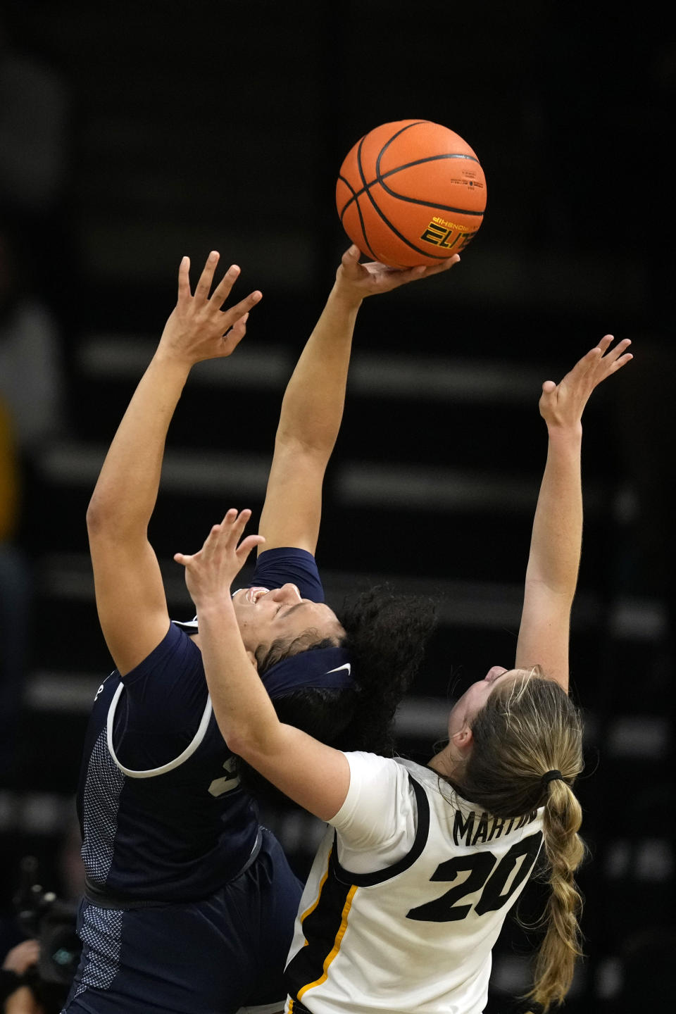 Penn State guard Leilani Kapinus (5) is fouled by Iowa guard Kate Martin (20) during the first half of an NCAA college basketball game, Thursday, Feb. 8, 2024, in Iowa City, Iowa. (AP Photo/Charlie Neibergall)