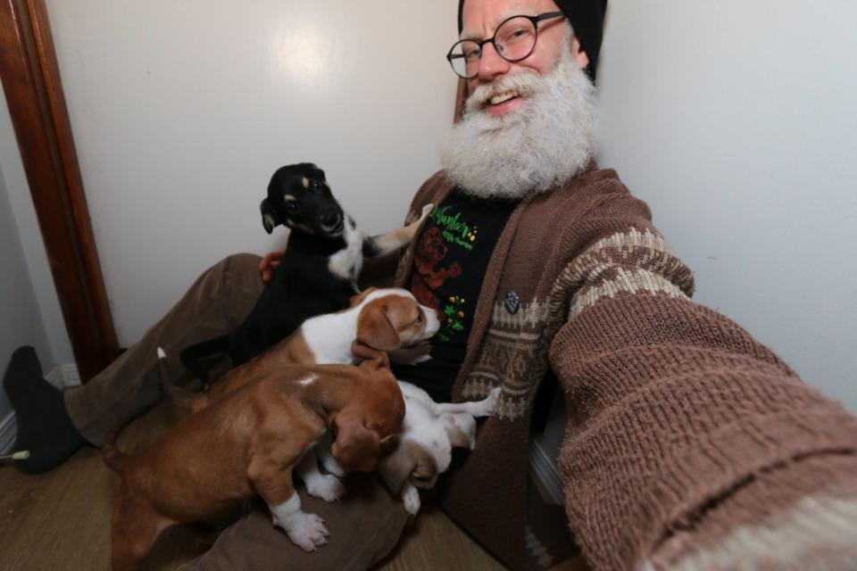 Santa Steve enjoys a puppy cuddle between North Pole visits. Photo: Facebook