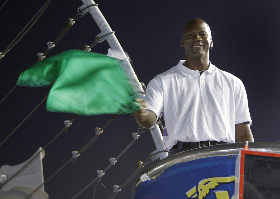 Charlotte Bobcats owner Michael Jordan practices waving the green flag before the NASCAR All-Star auto race at Charlotte Motor Speedway in Concord, N.C., Saturday, May 22, 2010. Jordan was the honorary starter for the race. (AP Photo/Chuck Burton)