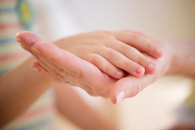 Mother and daughter's hands, close-up - Credit: Jamie Grill/Getty iStock