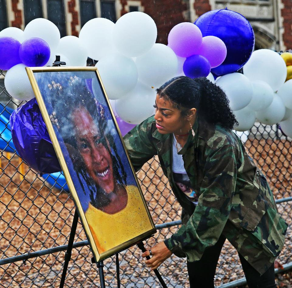 Ayanna Patterson displays a portrait of her daughter Alexis Patterson on the 20th anniversary of her disappearance on Tuesday, May 3, 2022, at the Hi-Mount Community School.