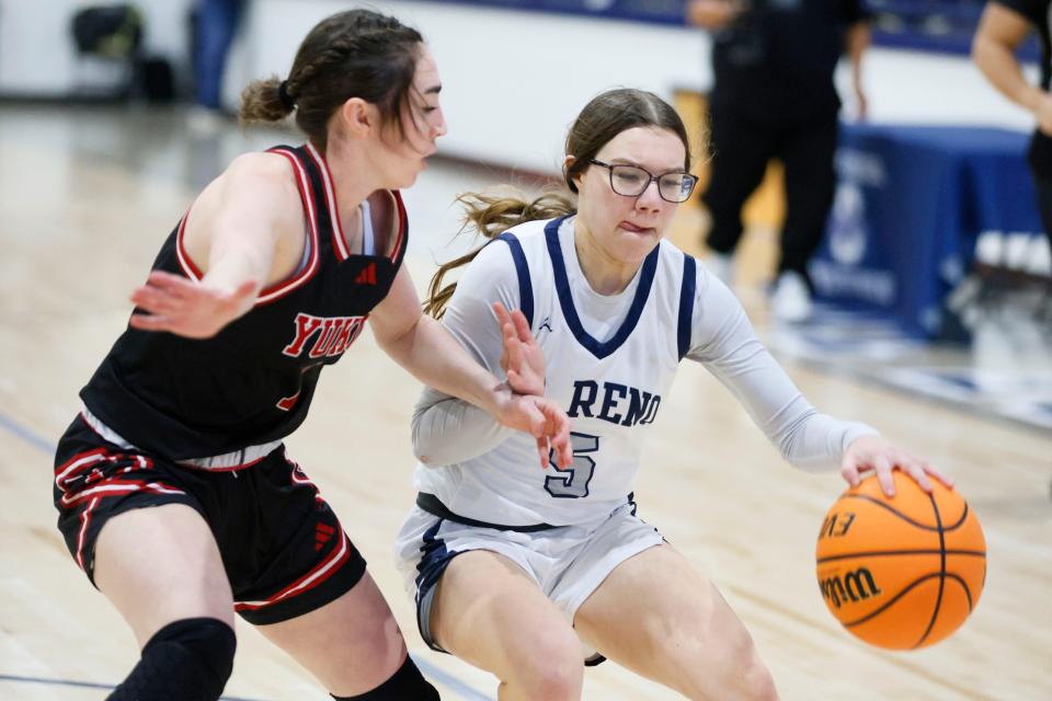 El Reno's Raegan Bugaj tries to get past Yukon's Caid Jefferson during the Shawnee Invitational basketball tournament championship game between El Reno and Yukon in Shawnee, Okla., Saturday, Jan. 20, 2024.