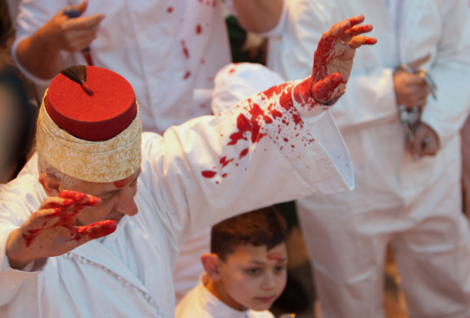 Members of the ancient Samaritan community participate in the ritual of Passover Sacrifice on Mount Grizim, overlooking the West Bank town of Nablus, Sunday, April 13, 2014. Samaritans descended from the ancient Israelite tribes of Menashe and Efraim but broke away from mainstream Judaism 2,800 years ago. Today, the remaining 700 Samaritans live in the Palestinian city of Nablus in the West Bank and the Israeli seaside town of Holon, south of Tel Aviv. (AP Photo/Nasser Ishtayeh)