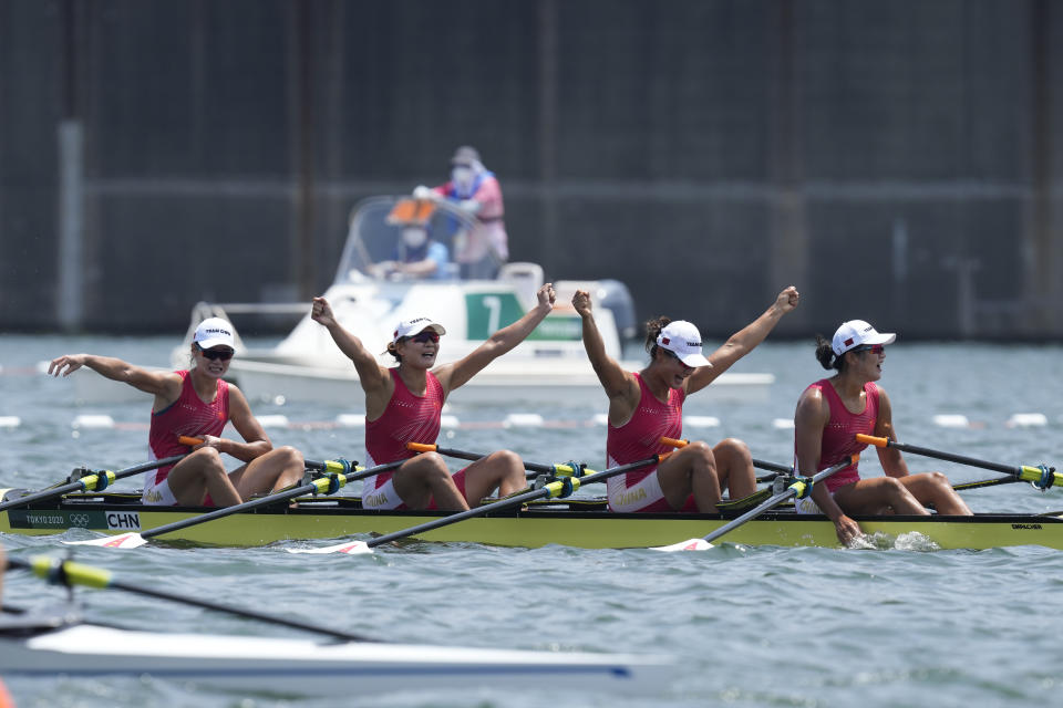 Chen Yunxia, Zhang Ling, Lyu Yang and Cui Xiaotong of China celebrate after winning gold in the women's rowing quadruple sculls final at the 2020 Summer Olympics, Wednesday, July 28, 2021, in Tokyo, Japan. (AP Photo/Darron Cummings)