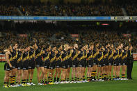 The Tigers line up before the start of the round nine AFL match between the Richmond Tigers and the Essendon Bombers at Melbourne Cricket Ground.