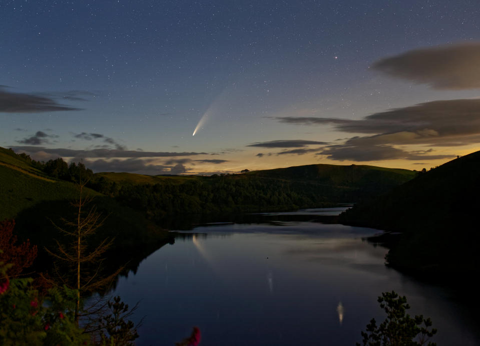 Comet Neowise passes over lake Vymwy in Wales on 11 July 2020. See SWNS story SWBRcomet.  