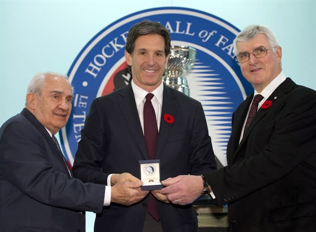 Hockey Hall of Fame inductee Brendan Shanahan is presented with his ring by chairman Pat Quinn (right) and chair of the selection committee Jim Gregory at the Hall in Toronto on Friday November 8, 2013. THE CANADIAN PRESS/Frank Gunn