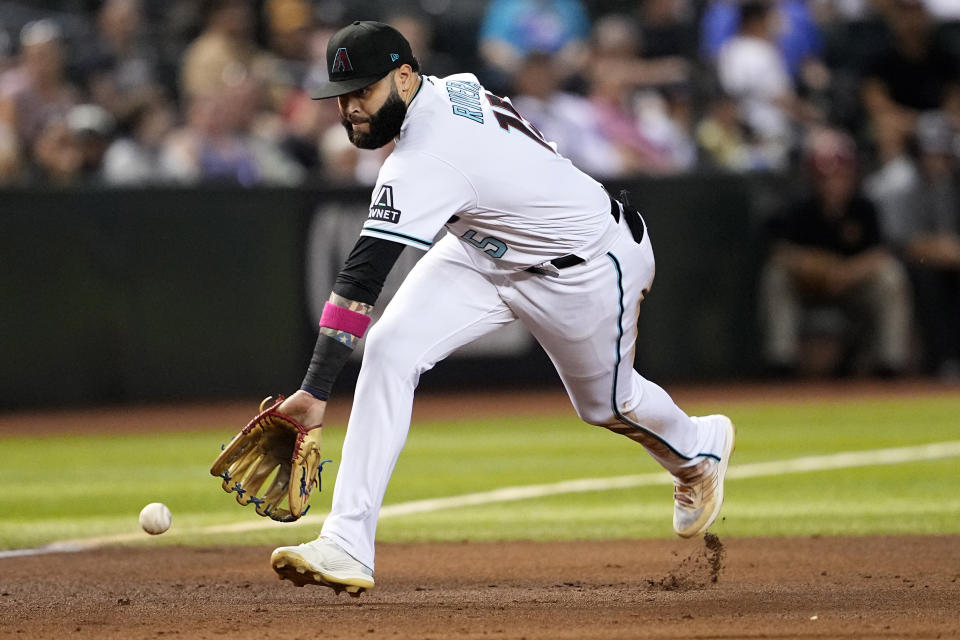 Arizona Diamondbacks' Emmanuel Rivera fields a ground out hit by Colorado Rockies' Brenton Doyle during the sixth inning of a baseball game, Tuesday, Sept. 5, 2023, in Phoenix. (AP Photo/Matt York)