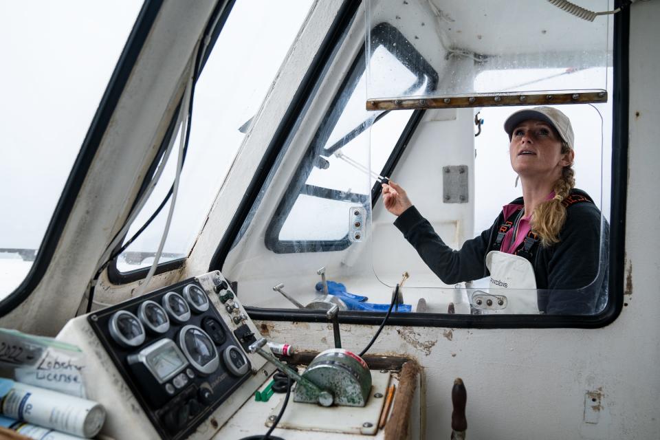 Krista Tripp checks her radar as she navigates out of South Thomaston Harbor to lobster in Maine on Friday, June 30, 2023.