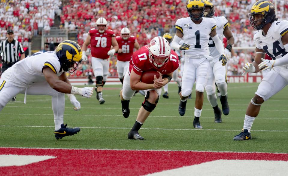 Wisconsin Badgers quarterback Jack Coan (17) scores a rushing touchdown against Michigan on Saturday, Sept. 21, 2019.
