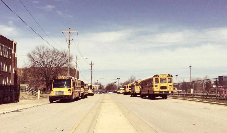 Buses wait outside duPont Manual High School in Louisville today (Alana Semuels)