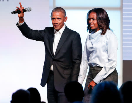 Former U.S. President Barack Obama and former first lady Michelle Obama greet guests during the first day of the Obama Foundation Summit in Chicago, Illinois, U.S. October 31, 2017. REUTERS/Kamil Krzaczynski