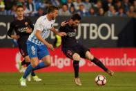 Football Soccer - Malaga v Barcelona- Spanish La Liga Santander - La Rosaleda Stadium, Malaga, Spain - 8/4/17 - Barcelona's Lionel Messi (R) and Malaga's Ignacio Camacho in action. REUTERS/Jon Nazca