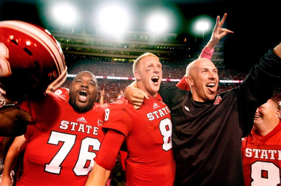 N.C. State quarterback Mike Glennon (8), his brother Sean, and Deylan Buntyn (76) celebrates N.C. State’s 17-16 victory over Florida State at Carter-Finley Stadium in October 2012.