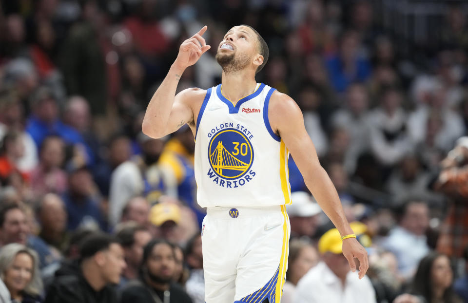 Golden State Warriors guard Stephen Curry reacts after hitting a 3-point-basket in the second half of Game 4 of an NBA basketball first-round Western Conference playoff series against the Denver Nuggets, Sunday, April 24, 2022, in Denver. (AP Photo/David Zalubowski)