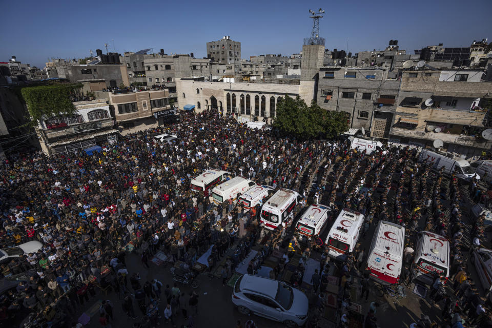 FILE - Mourners pray for members of the Palestinian Abu Raya family that died in a fire in their apartment building in the Jebaliya refugee camp, northern Gaza Strip, Friday, Nov. 18, 2022. A house fire that killed 22 Palestinians from one family who gathered this week for a celebration was caused when a family member used gasoline during a stunt show before losing control, Gaza’s Hamas authorities said Sunday. (AP Photo/Fatima Shbair, File)