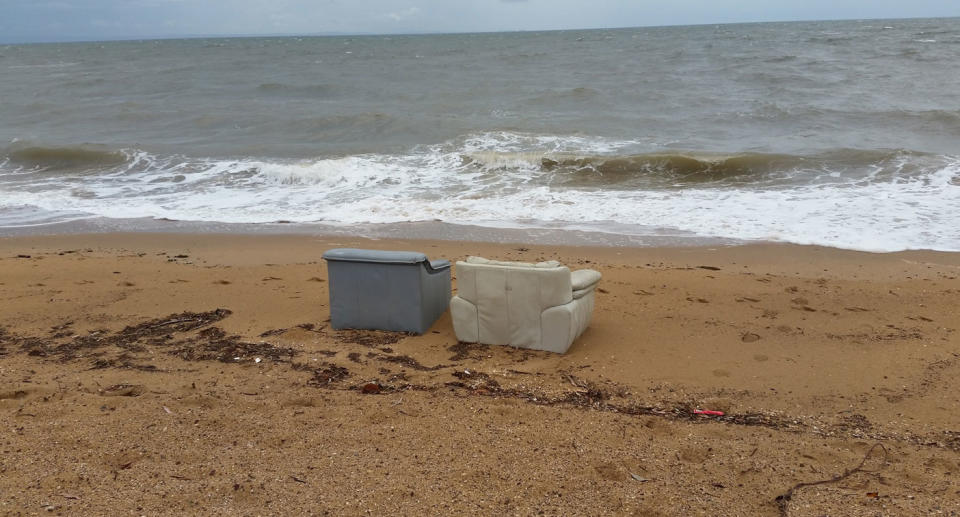 Two couches sit on a beach in Redcliffe north of Brisbane.