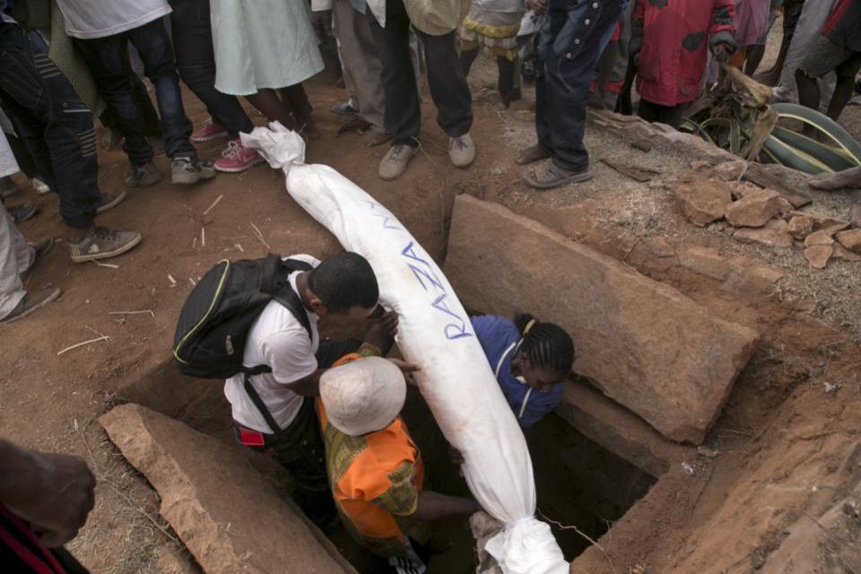 Dead bodies are dug from their graves (Picture: AFP)