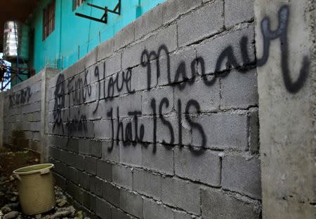 A graffiti is seen on a wall of a back alley as government soldiers continue their assault against the Maute group, who have taken over parts of Marawi City, Philippines June 22, 2017. REUTERS/Romeo Ranoco