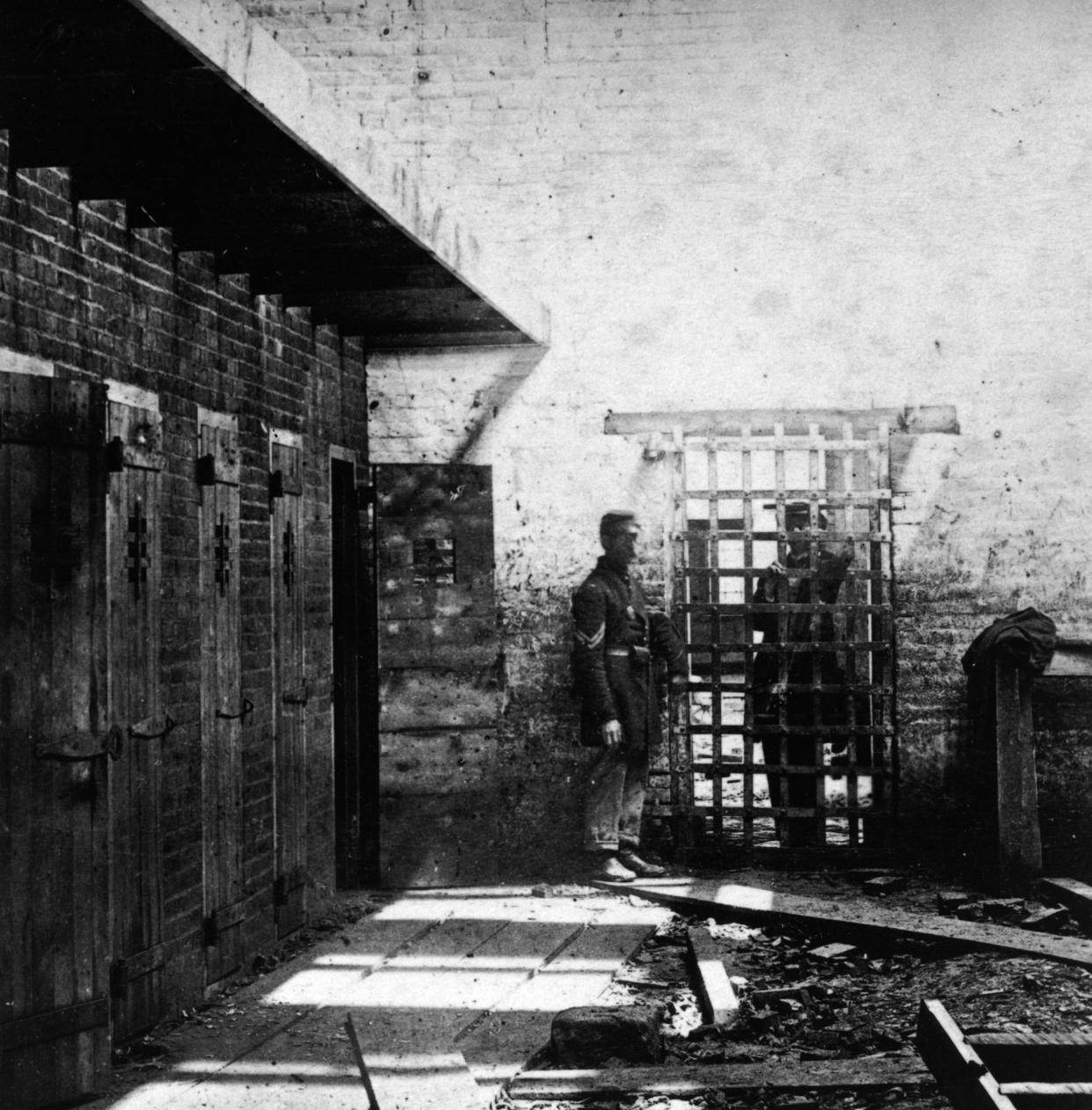 Two soldiers stand beside cells where enslaved Black people were confined in Alexandria, Virginia, circa 1861.  (Photo: Archive Photos via Getty Images)