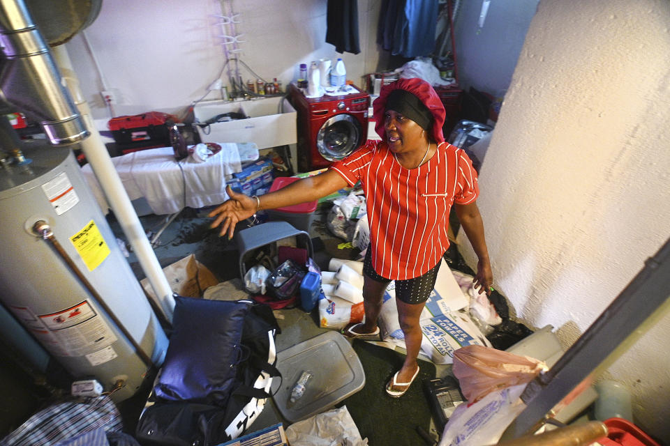 Mary Mason shows her frustration after floodwaters damaged her basement in Detroit on Saturday, June 26, 2021. (Max Ortiz/Detroit News via AP)