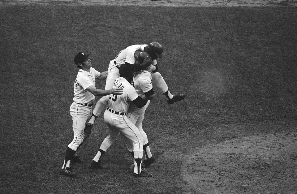 Detroit Tigers' Jim Northrup is mobbed by his teammates after he singled in the 10th inning to go ahead and win Game 4 of the team's series with the Oakland Athletics on Wednesday, Oct. 11, 1972. Tigers Ike Brown climbs on Northrup’s shoulders with Dick McAuliffe, left, and Tony Taylor moving in. AP FILE PHOTO