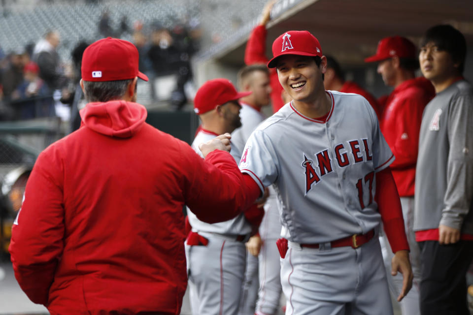 Los Angeles Angels' Shohei Ohtani smiles with manager Brad Ausmus, left, before a baseball game against the Detroit Tigers in Detroit, Tuesday, May 7, 2019. (AP Photo/Paul Sancya)